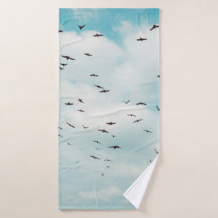 Un rebaño de paloma gris vuela sobre el cielo azul