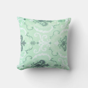 Una almohada decorativa verde suave pastel
