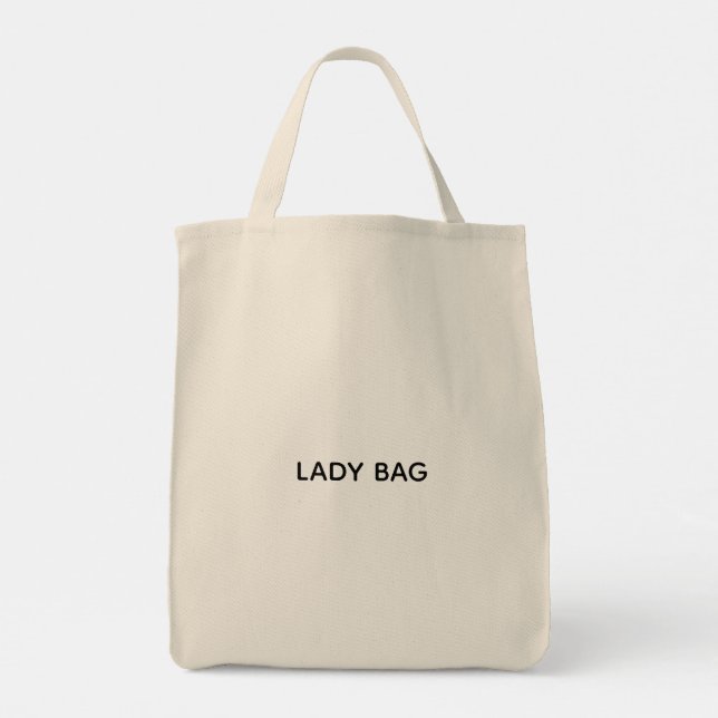 Una bolsa tote beige con el texto "LADY BAG" impre (Reverso)