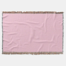 Una manta decorativa rosa con un sutil 