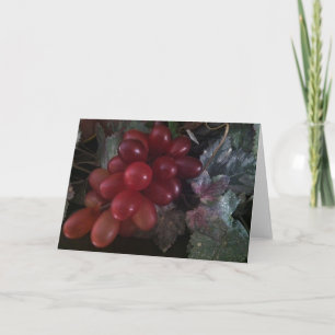 Uvas en tarjeta de felicitación de las hojas
