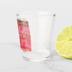 Vaso De Chupito un diseño de fondo rosa y dorado con un rojo