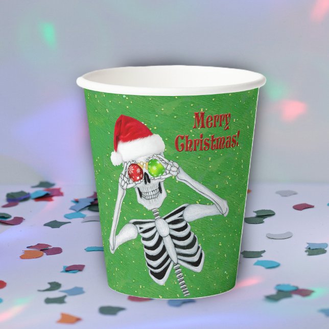 Vasos De Papel Navidades Skeleton Ornaments Gorra Green (Fun Merry Christmas skeleton ornament eyes Santa Hat on green party drinking paper cups.)