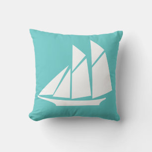 velero blanco sobre almohada azul turquesa