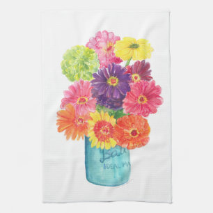 Zinnias en toalla de cocina de enlatado azul del
